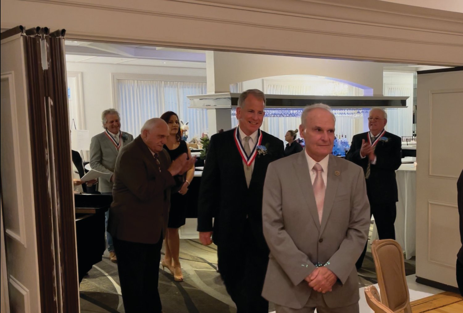 MAKING AN ENTRANCE: Fred Vincent, past president of the Cranston Hall of Fame Foundation’s board, escorts inductee Jeffrey Lanphear into last week’s dinner. Looking on, from left, are Anthony Tomaselli, Ken Mancuso, Superintendent Jeannine Nota-Masse and William Stamp.